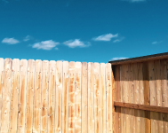 Timber fencing with blue sky backdrop