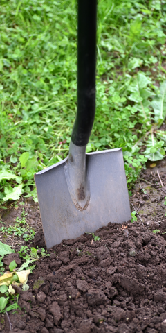 Close up of shovel in soil